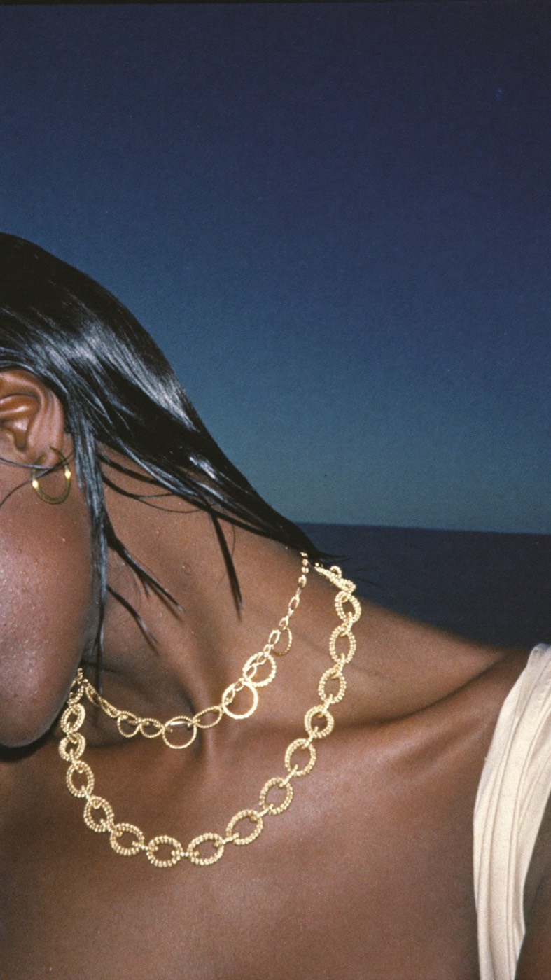 Gold chains at night by the sea