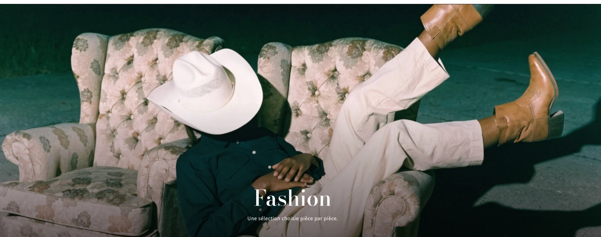 The Fashion collection page: a man in a white hat and boots lounging on armchairs at night